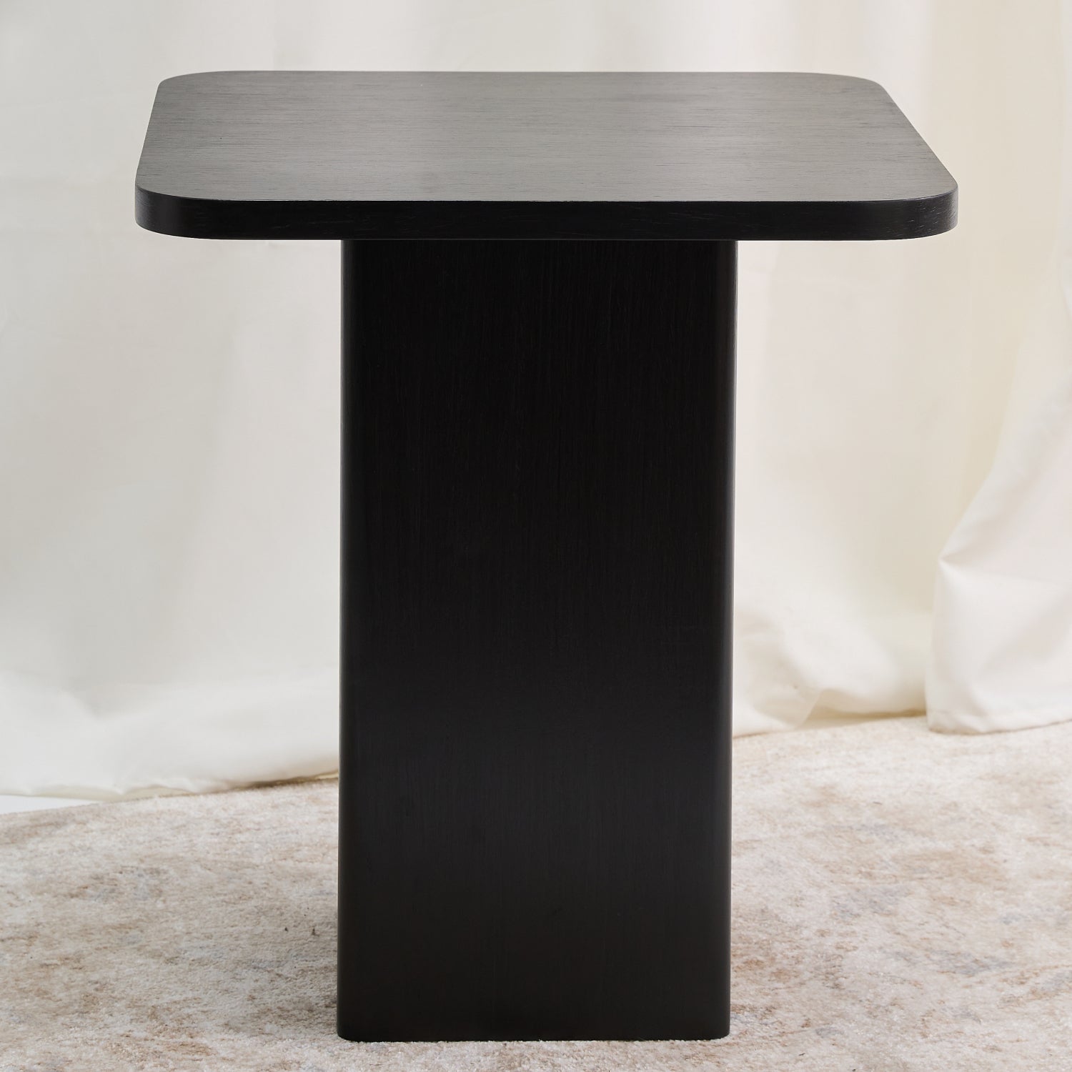 Mesa con una estructura ortogonal que se suaviza con sutiles curvas en el tablero y la base, creando una sensación de armonía. Color carbón.