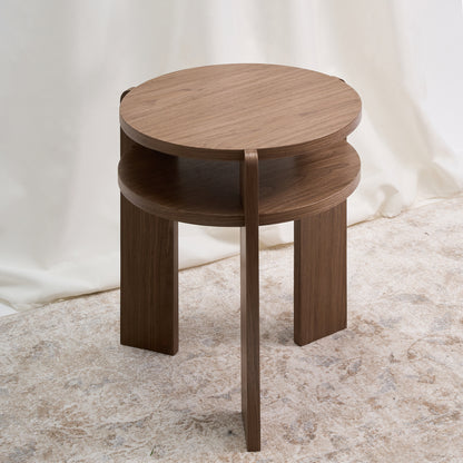 Mesa con un diseño combina geometría circular y estructura vertical con una precisión que sorprende por su simplicidad. Color nuez.